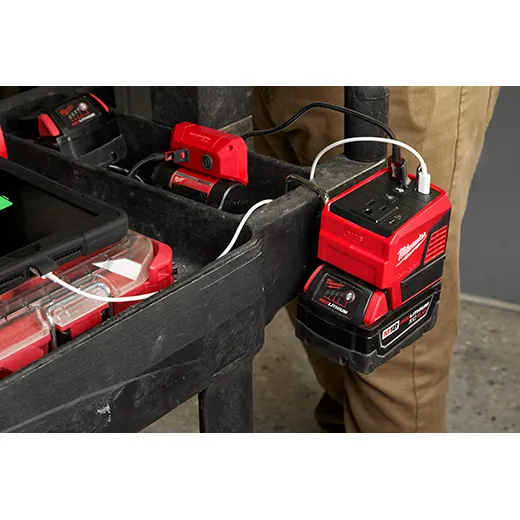 Milwaukee M18 battery power supply charging multiple devices on a jobsite cart, showcasing the versatility and reliability of Milwaukee’s battery-powered charging solutions available at Spearfish Building Supply.