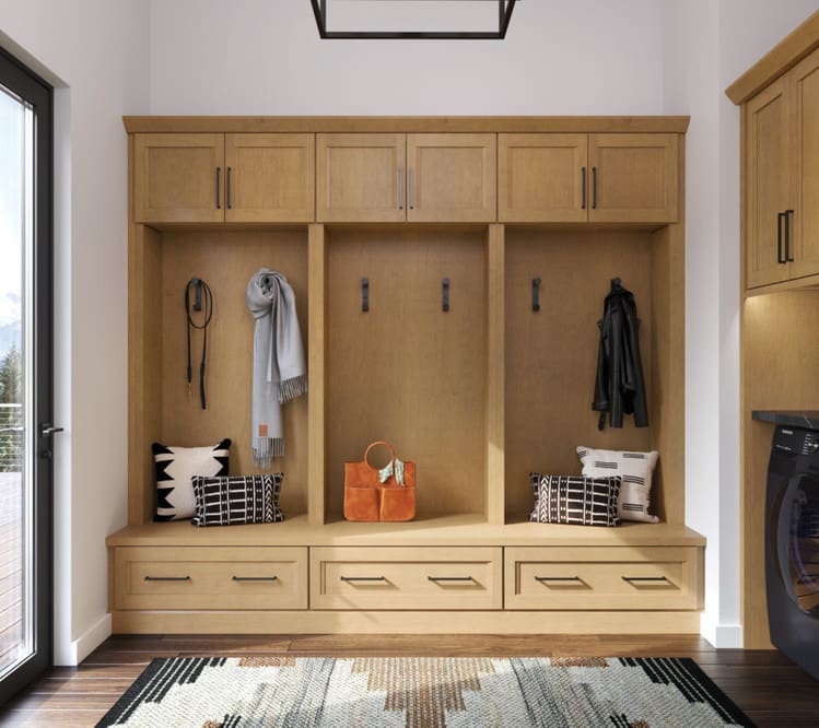 Custom mudroom cabinetry with built-in storage cubbies, drawers, and upper cabinets in a natural wood finish—designed and provided by Spearfish Building Supply in Spearfish, SD.