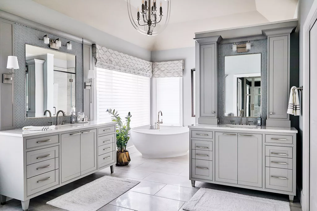 Elegant bathroom with custom gray cabinetry, dual vanities, and a freestanding soaking tub—cabinetry provided by Spearfish Building Supply in Spearfish, SD.